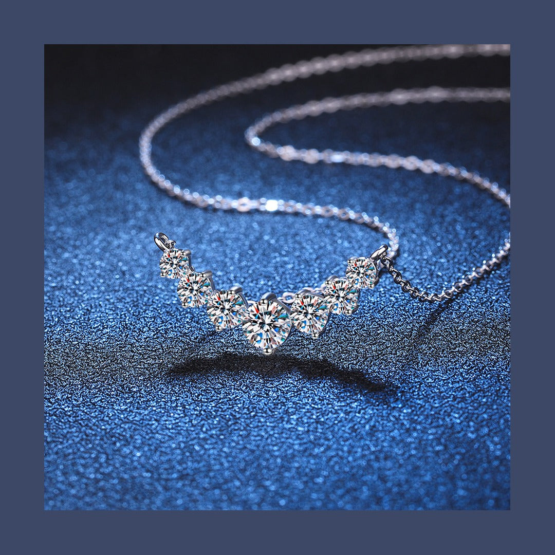 Graduated moissanite necklace on blue background