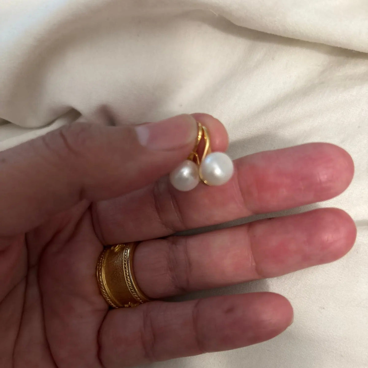 Cultured Freshwater Pearl Drop Earrings, pair held on fingertips