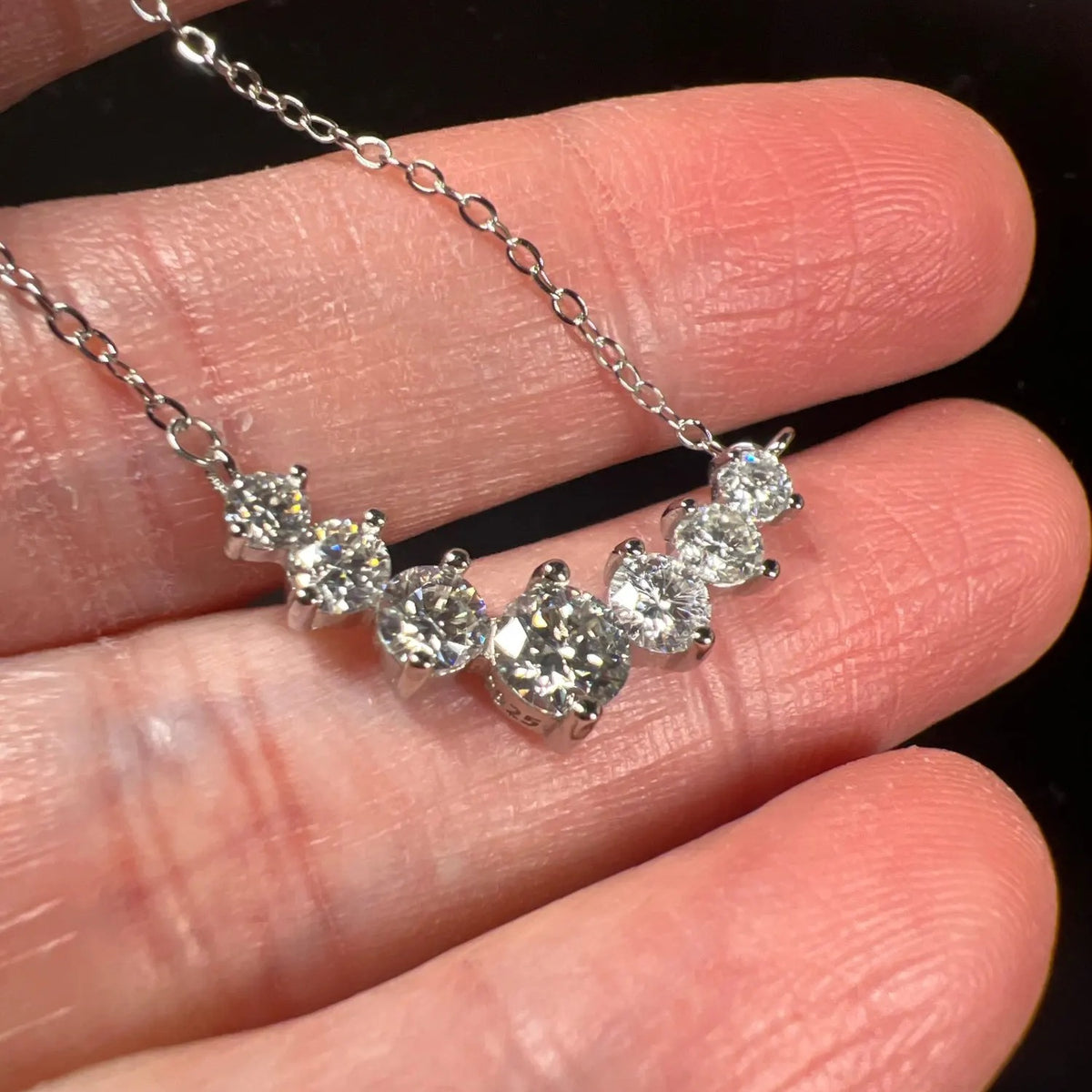 Graduated Lab-Created Moissanite Necklace, held in hand