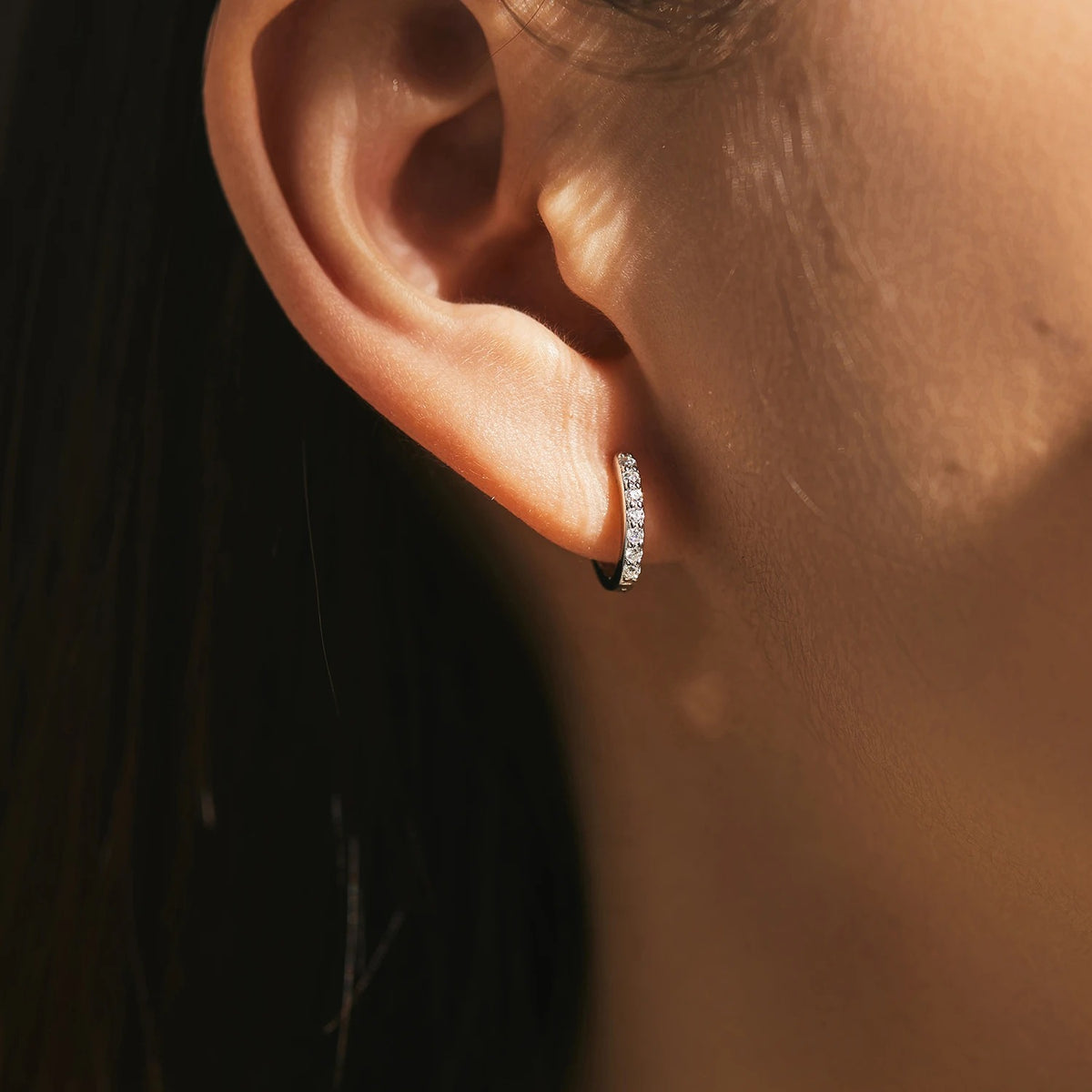 Lab-Created Moissanite Eternity Hoop Earrings, worn on the ear