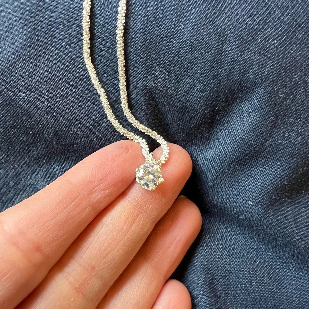 Lab-Created Moissanite Solitaire Pendant Necklace, pendant held in hand