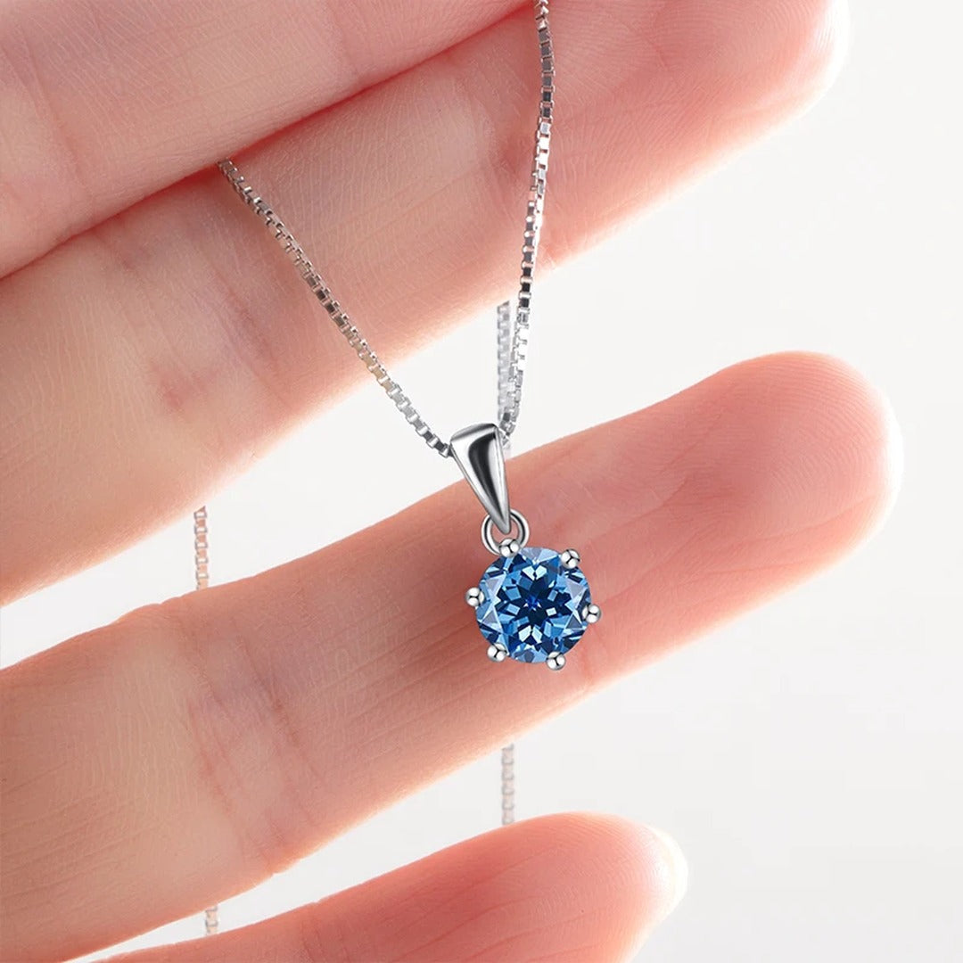 Royal Blue Lab-Created Moissanite Solitaire Pendant Necklace, pendant held in hand