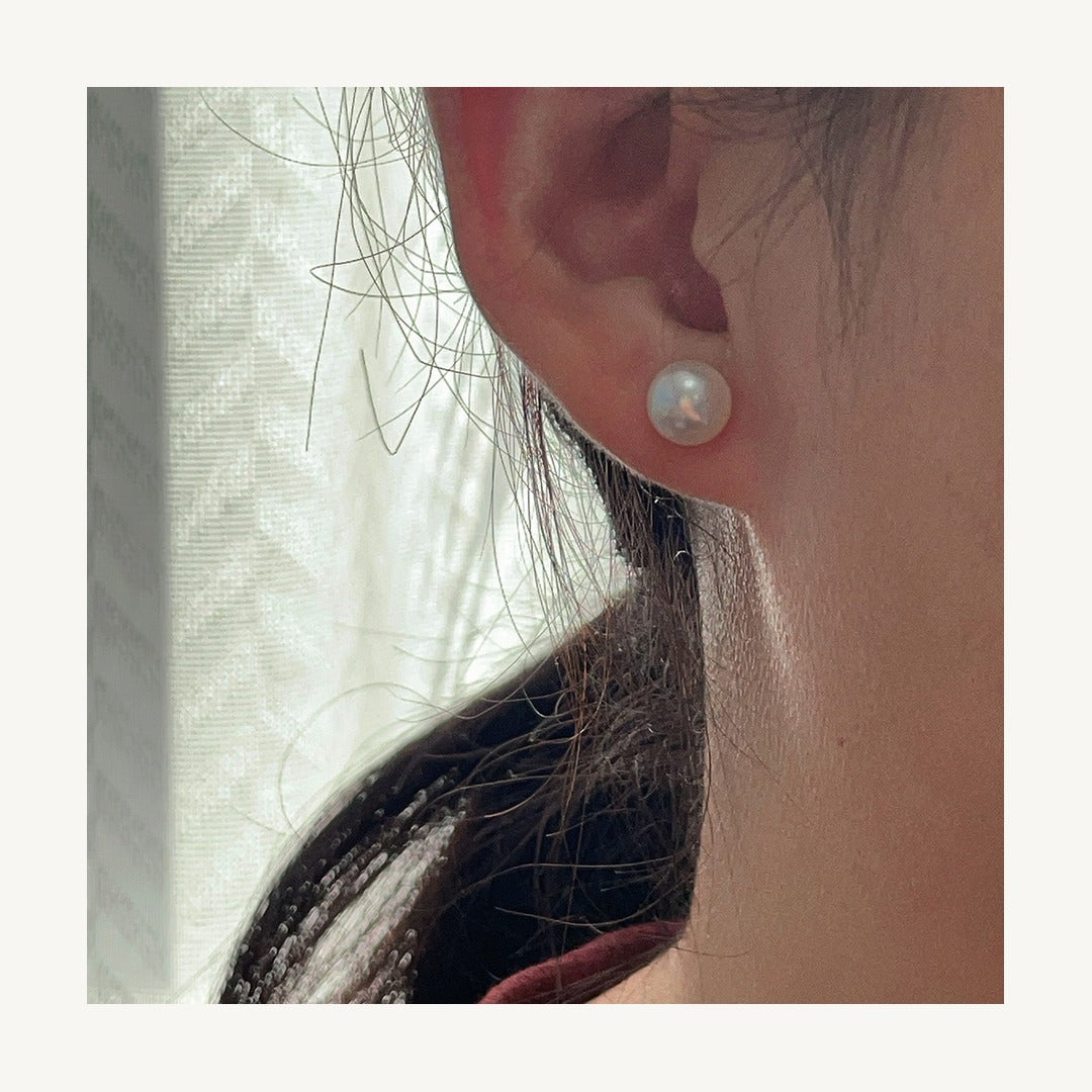 Cultured freshwater pearl stud earring worn